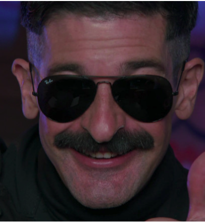 What Sunglasses Does Robert Ben Garant as Deputy Travis Junior Wear in Reno 911?